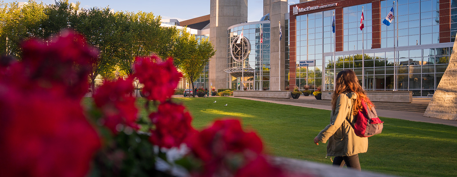 macewan exterior of campus with student walking