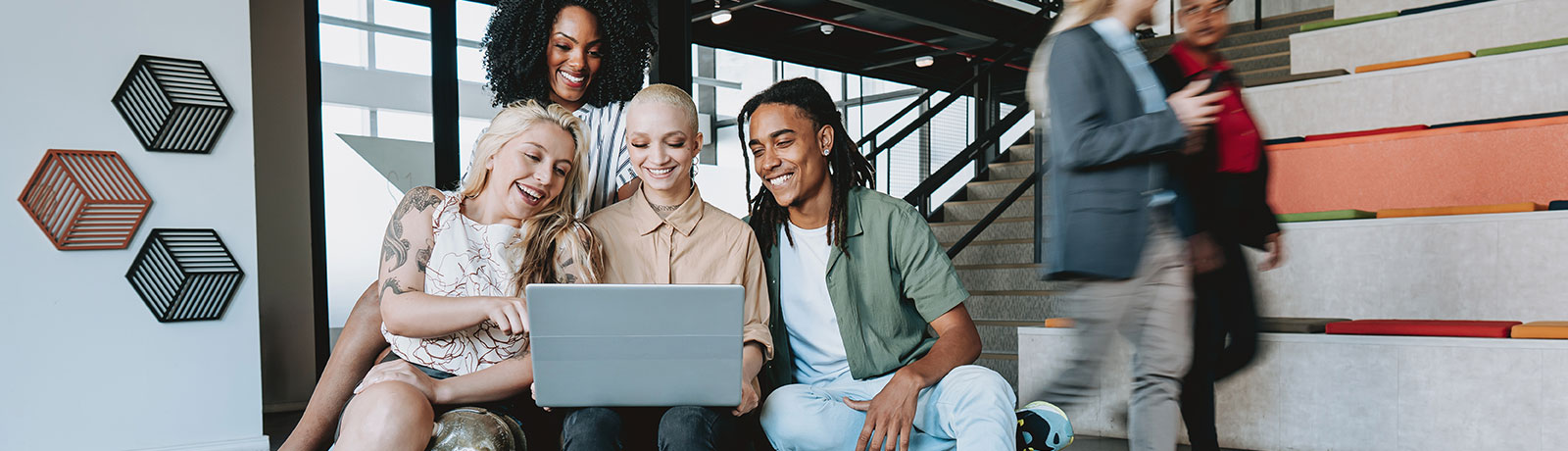 Group of oeioke looking at laptop