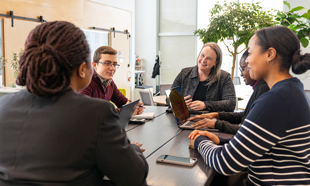 group of people at computers around table