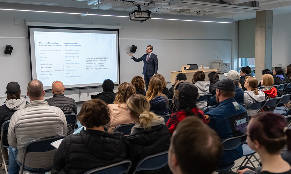 instructor pointing to screen with class watching