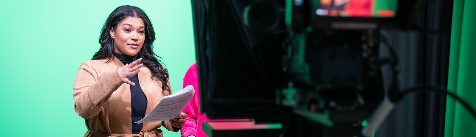 student in front of camera in tv studio