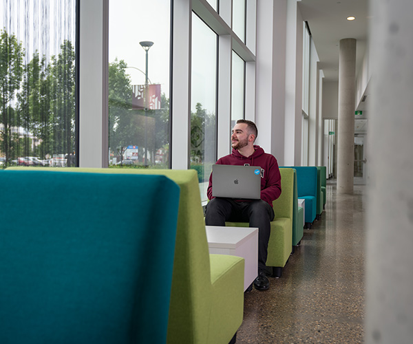 male student looking out window