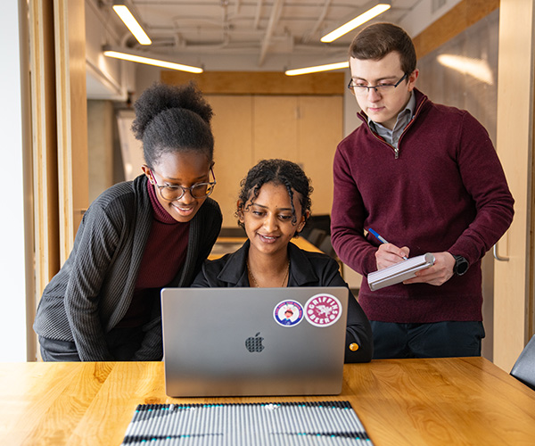 students looking at laptop