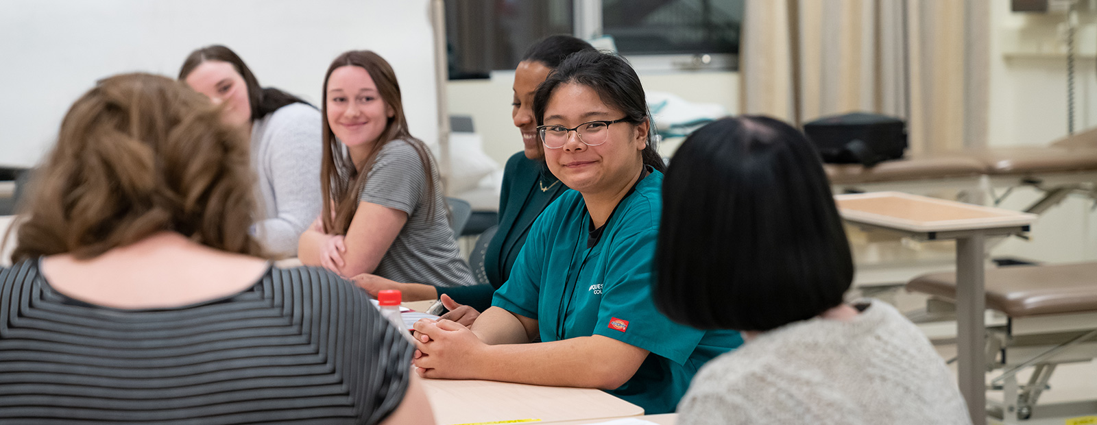 students speaking around table