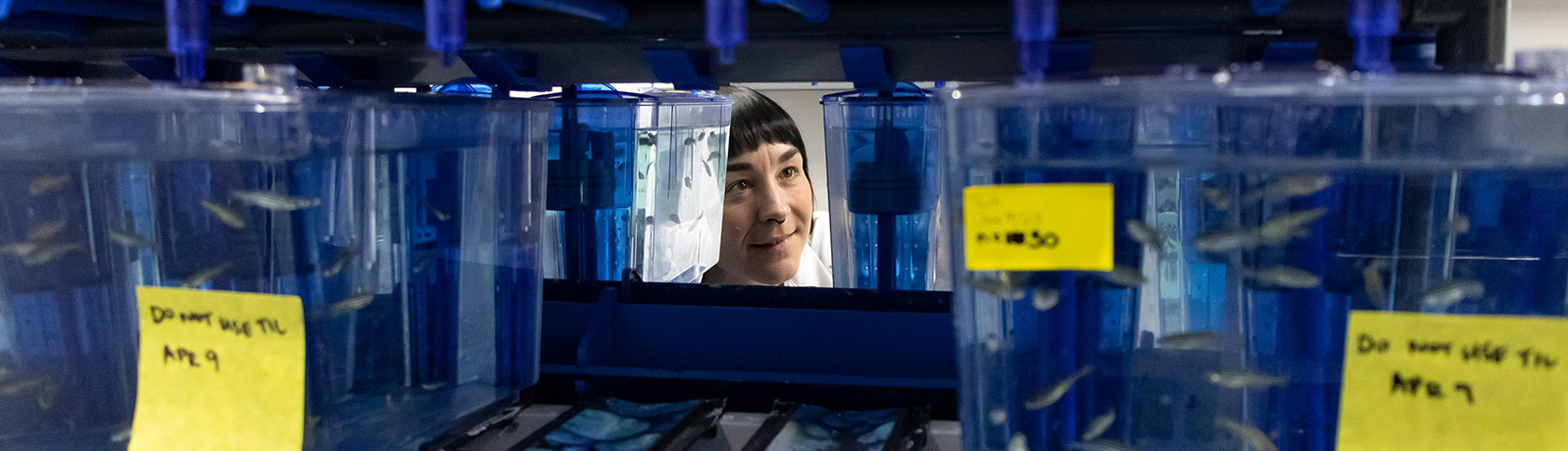 female student with fish in lab