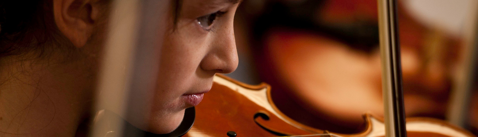 close up of student playing violin