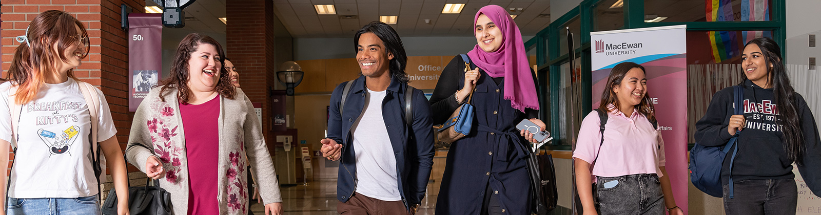 students walking down MacEwan hallway