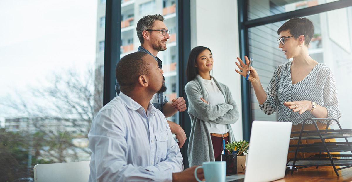 A group of people discuss an idea in an office space