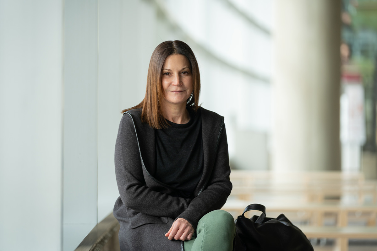 Dr. Margot Jackson sits on a couch in Allard Hall