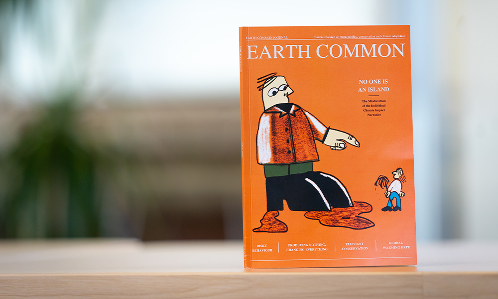 A copy of Earth Common Journal sits on a table top