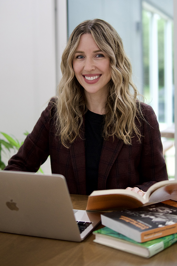 Jillian Turanovic sits at a desk with a laptop computer in front of her.