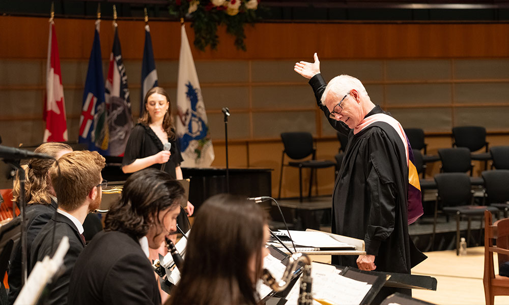 Ray Baril directs the Big Band holding his right palm up high