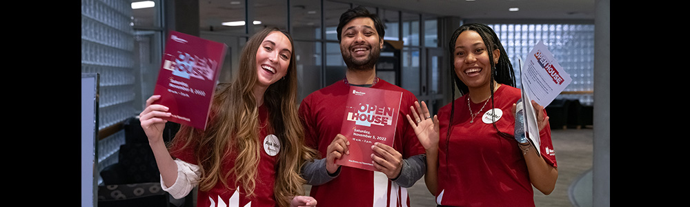 smiling students wear MacEwan shirts at Open House