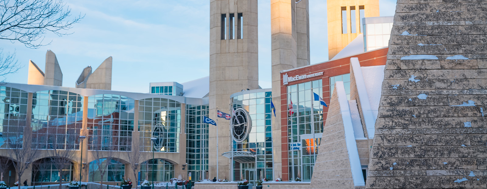 MacEwan's clock tower entrance seen on a winter morning with light snow on the ground.