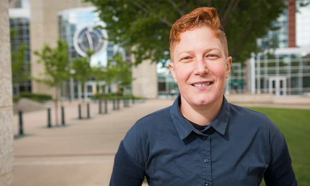 Dr. Alissa Overend stands in front of MacEwan's clock tower.