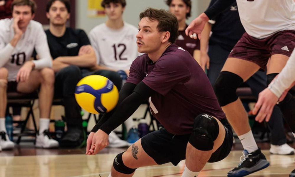 Daniel Hebert bumps a volleyball during a Griffins game