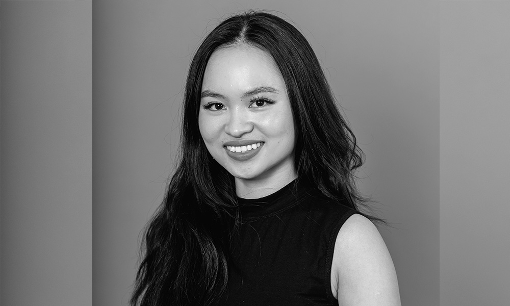 A black and white photo of Nhi Phan smiling