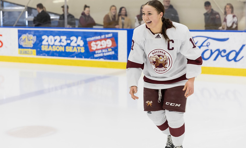 Sydney skates across the ice in her Griffins hockey uniform
