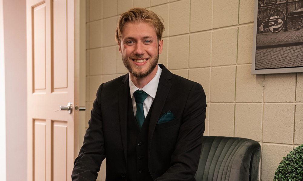 Michael Black sits on a chair in an office