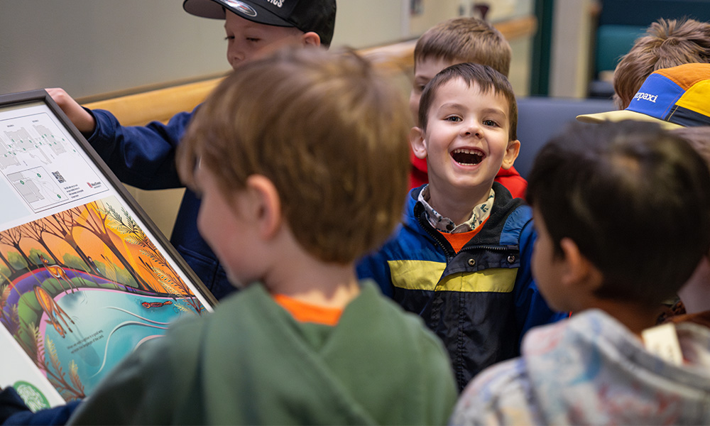 A child smiles while looking directly at the camera