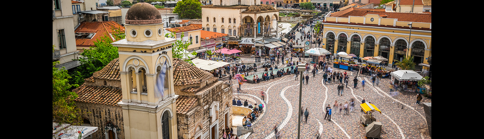 People walking over the Monastiraki Square in Athens, Greece.