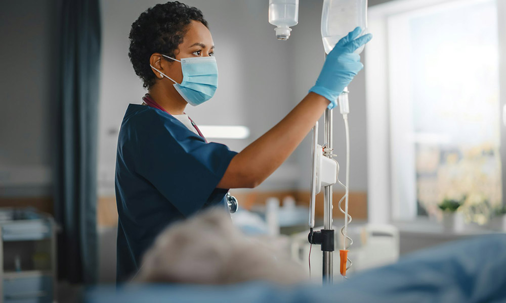 A nurse checks an IV