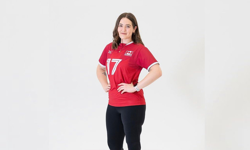 Allison Lang poses on her Team Canadsjersey with her hands on her hips