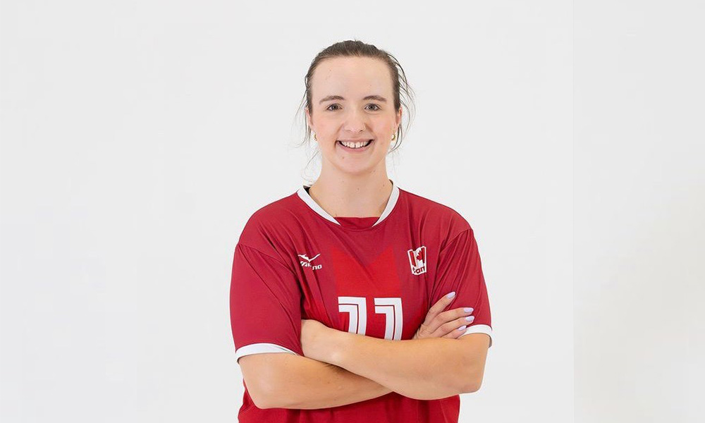 Heidi Peters crosses her arms and smiles wearing her Team Canada jersey