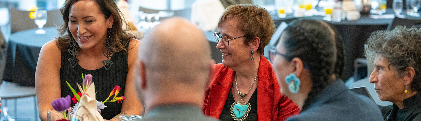 Dr. Annette Trimbee speaks with people at an event