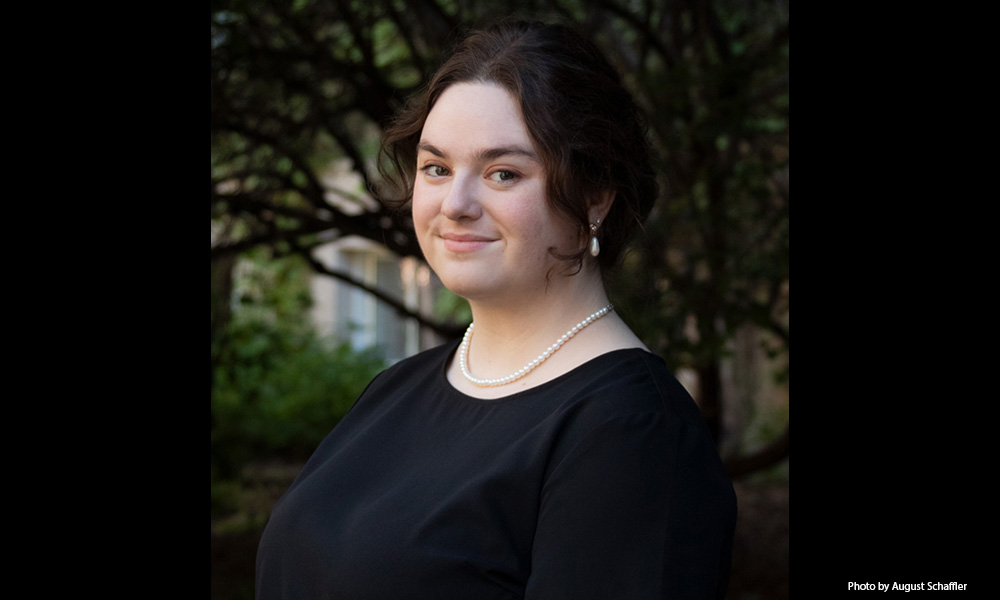 A headshot of Samantha Dancey, standing in front of some trees.