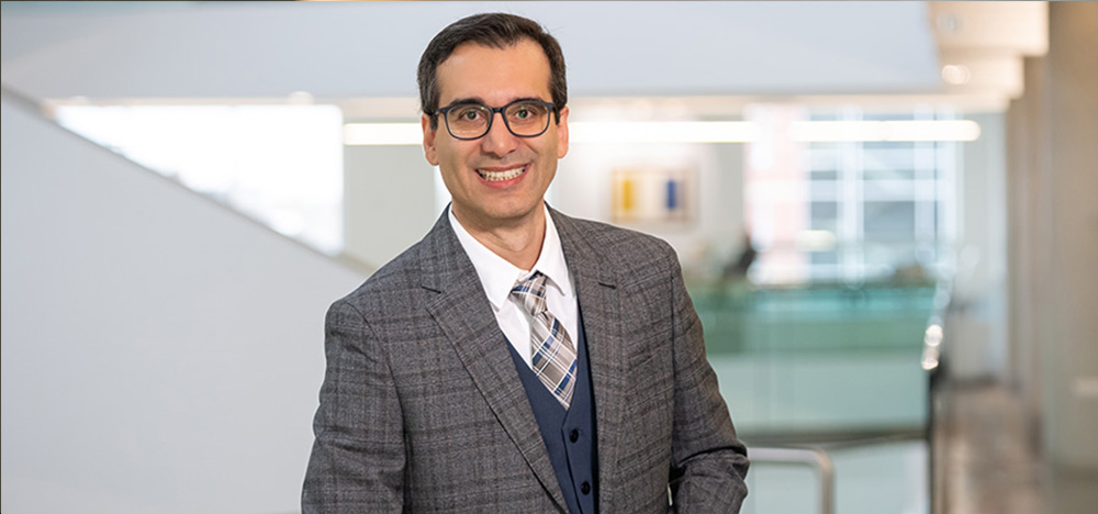 Dr. Farzan Baradaran Rahimi stands in Allard Hall