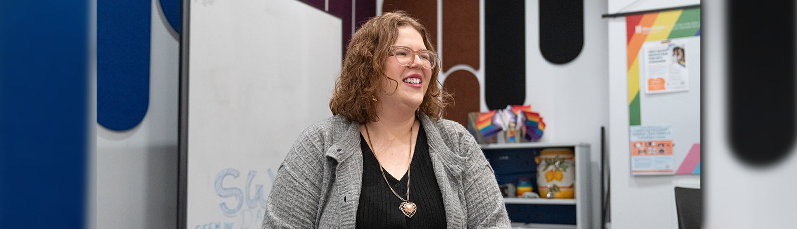 Wren Ferguson sits in the common room in the Centre for Sexual and Gender Diversity