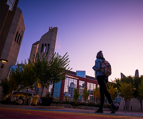 student walking outside macewan