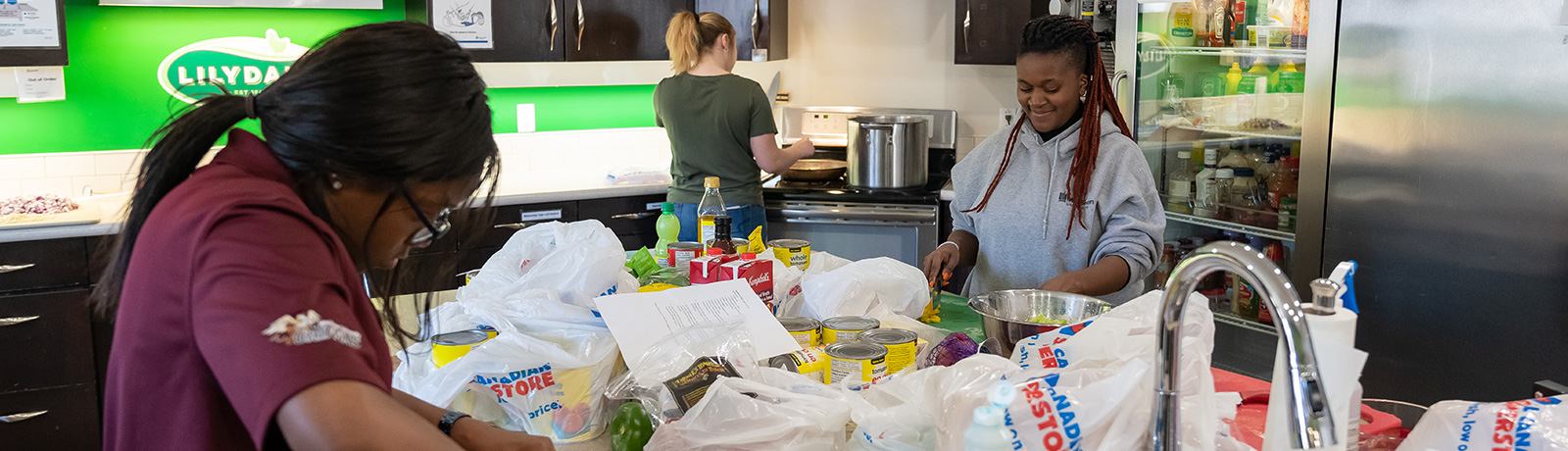 students volunteering in kitchen