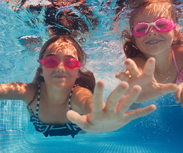 two children swimming underwater