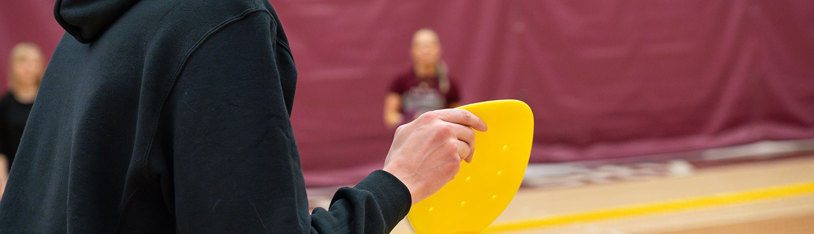 student in gym playing sports