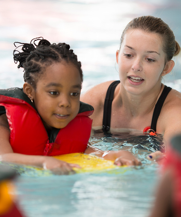 swim instructor with child in pool